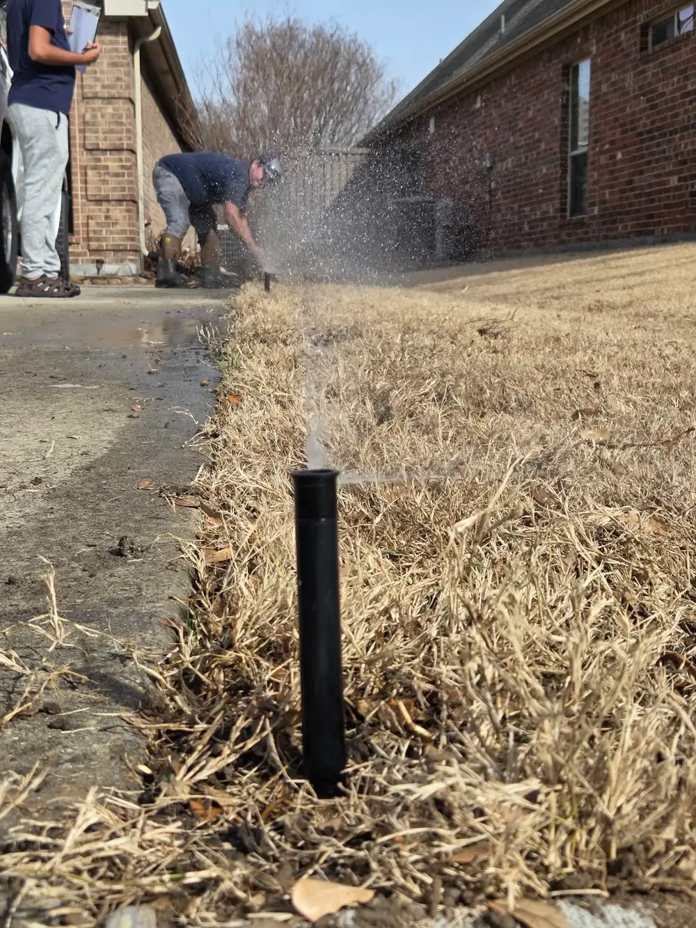Sprinkler head test with technician in background