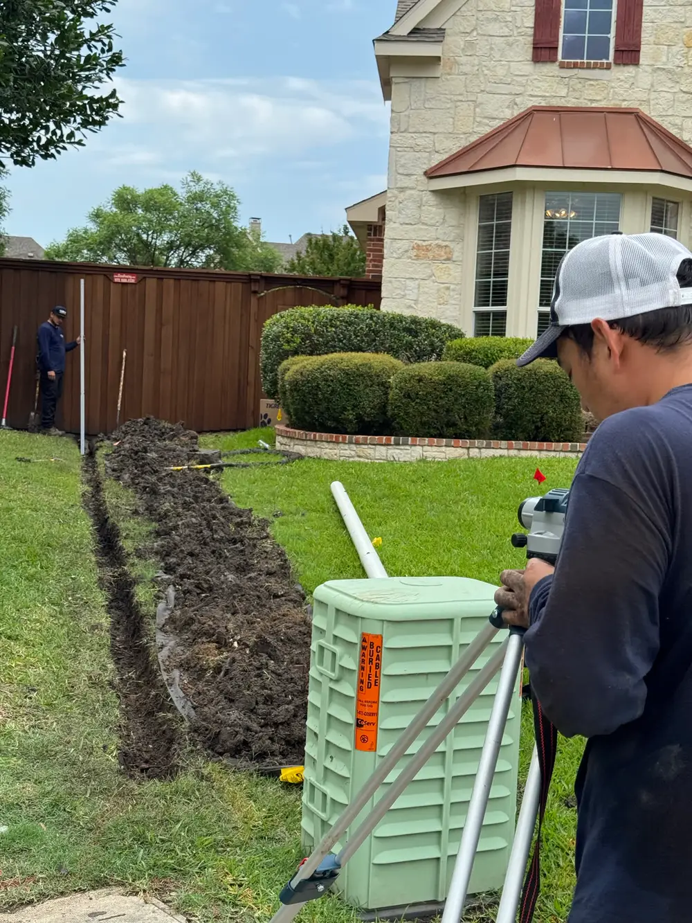 Carson tech carrying valve box at residential drainage job